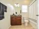 Cozy bathroom featuring a granite vanity, ceramic tile flooring, and a shower-tub combo at 235 Whispering Hills Dr, Locust, NC 28097