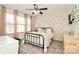 A charming bedroom featuring a floral accent wall, natural light and stylish decor at 235 Whispering Hills Dr, Locust, NC 28097