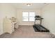 A bonus room features a desk, a treadmill, and a window with natural light at 235 Whispering Hills Dr, Locust, NC 28097