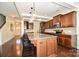 Modern kitchen with granite countertops, stainless appliances, a center island with seating, and dark wood cabinetry at 235 Whispering Hills Dr, Locust, NC 28097