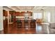 Well-equipped kitchen with stainless steel appliances, a spacious island with bar stools, and hardwood floors at 235 Whispering Hills Dr, Locust, NC 28097