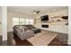 Relaxing living room featuring plush sofas, an electric fireplace, and a large flat-screen television at 235 Whispering Hills Dr, Locust, NC 28097