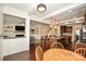 Open-concept living area boasts hardwood floors, a kitchen island with granite countertops, and a cozy living room at 235 Whispering Hills Dr, Locust, NC 28097