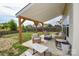 Inviting covered patio with comfortable seating, an outdoor dining area, and a cozy fire pit for relaxing evenings at 235 Whispering Hills Dr, Locust, NC 28097