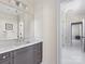 Stylish bathroom featuring a gray vanity, modern lighting, and doorway to a shower and more rooms at 2500 Marshall Pl, Charlotte, NC 28203