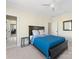 This bedroom features neutral walls, carpet, a ceiling fan, and a dark wood bed frame at 2500 Marshall Pl, Charlotte, NC 28203