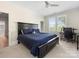 Cozy bedroom featuring a plush bed, window with natural light, and a desk area for working at 2500 Marshall Pl, Charlotte, NC 28203
