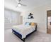 Comfortable bedroom featuring carpeted floors, large window, and stylish bed with doorway access at 2500 Marshall Pl, Charlotte, NC 28203