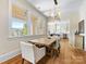 Dining area with wood floors, a rustic table, and views into the kitchen at 2500 Marshall Pl, Charlotte, NC 28203