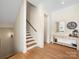Welcoming entryway featuring hardwood floors, staircase, and decorative mirror over a console table at 2500 Marshall Pl, Charlotte, NC 28203