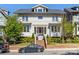 Charming two-story home features a symmetrical facade, manicured landscaping, and inviting front porch with seating at 2500 Marshall Pl, Charlotte, NC 28203