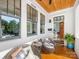 Inviting front porch with wicker chairs, wood ceiling, and a view of the front door and interior at 2500 Marshall Pl, Charlotte, NC 28203