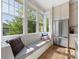 Bright kitchen nook featuring a built-in bench, large windows, and stainless fridge at 2500 Marshall Pl, Charlotte, NC 28203
