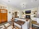 Cozy living room with hardwood floors, fireplace, and an open view to the dining area and front entry at 2500 Marshall Pl, Charlotte, NC 28203