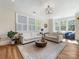 Spacious living room with hardwood floors, natural lighting, comfortable seating, and stylish chandelier at 2500 Marshall Pl, Charlotte, NC 28203