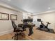 This home office features a modern desk, two monitors, a leather chair, and a Peloton exercise bike at 2500 Marshall Pl, Charlotte, NC 28203