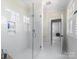 Modern bathroom with a glass-enclosed shower, subway tile, and bright natural light from the window at 2500 Marshall Pl, Charlotte, NC 28203