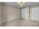 Bedroom with two closets, neutral paint and carpet, and a modern light fixture at 2848 Briar Ridge Dr, Charlotte, NC 28270