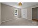 Bedroom with two windows, neutral paint and carpet, and a closet at 2848 Briar Ridge Dr, Charlotte, NC 28270