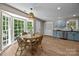 Bright and inviting dining area featuring a round table near a large bay window and updated kitchen at 2848 Briar Ridge Dr, Charlotte, NC 28270