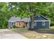 Charming blue home featuring a combination of brick and vinyl siding, complemented by a well-maintained front yard at 2848 Briar Ridge Dr, Charlotte, NC 28270