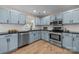 Updated kitchen featuring stainless steel appliances, black countertops, and light blue cabinets at 2848 Briar Ridge Dr, Charlotte, NC 28270