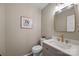 Stylish powder room with elegant fixtures, a gold mirror, and a modern vanity with marble countertop at 2848 Briar Ridge Dr, Charlotte, NC 28270