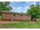 This is an image of the brick back exterior with lawn and patio at 302 Kimberlee Dr, Shelby, NC 28152