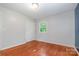 Bedroom featuring hardwood floors, closet door, and a window to bring in natural light at 302 Kimberlee Dr, Shelby, NC 28152