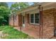 Close-up of a covered front porch featuring brick columns and large windows at 302 Kimberlee Dr, Shelby, NC 28152