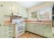 Functional kitchen with classic cabinets, neutral countertops, and a range at 302 Kimberlee Dr, Shelby, NC 28152
