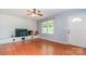Bright living room with hardwood floors and a white-painted brick fireplace feature at 302 Kimberlee Dr, Shelby, NC 28152