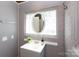 Well-lit bathroom with textured gray walls, glass block windows, and a gray vanity, offering a serene atmosphere at 311 Airport Rd, Rock Hill, SC 29732