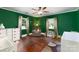 This bedroom has a ceiling fan, hardwood floors, 2 windows, white dresser and is designed for a Bedroom at 311 Airport Rd, Rock Hill, SC 29732