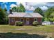 Charming brick home with a well-maintained lawn, traditional design, and inviting curb appeal under a partly cloudy sky at 311 Airport Rd, Rock Hill, SC 29732
