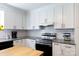 Bright kitchen showcasing white cabinets, modern appliances, and a subway tile backsplash, creating a clean and stylish cooking area at 311 Airport Rd, Rock Hill, SC 29732