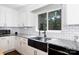 Modern kitchen featuring a stainless steel sink, white cabinetry, and granite countertops, creating a functional and stylish workspace at 311 Airport Rd, Rock Hill, SC 29732
