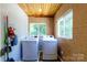 Bright laundry room with brick walls, wood paneled ceiling, and modern washer and dryer units at 311 Airport Rd, Rock Hill, SC 29732