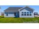 Exterior view of a light blue home with a gray roof and a green lawn at 355 Gray Wolf St # 122P, China Grove, NC 28023