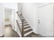 Hallway featuring a staircase with hardwood floors and white risers at 355 Gray Wolf St # 122P, China Grove, NC 28023