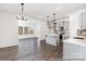Open-concept kitchen with gray cabinets, stainless steel appliances, quartz countertops and hardwood floors at 355 Gray Wolf St # 122P, China Grove, NC 28023