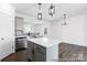 Modern kitchen featuring a central island with white countertops, gray cabinets, and stainless steel appliances at 355 Gray Wolf St # 122P, China Grove, NC 28023