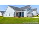 Lovely blue one-story home features a welcoming porch and a two-car garage with lush green lawn at 355 Gray Wolf St # 122P, China Grove, NC 28023