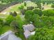 Scenic aerial view of the home on a golf course, enveloped by mature trees and lush landscaping at 3619 Chilham Pl, Charlotte, NC 28226