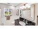 The bathroom features a large vanity mirror, a single sink, and a shower/tub combo at 3619 Chilham Pl, Charlotte, NC 28226