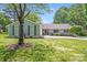 Charming ranch-style home with mature landscaping and a circular driveway on a sunny day at 3619 Chilham Pl, Charlotte, NC 28226