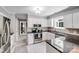 Bright kitchen featuring granite countertops, white cabinets, and stainless steel appliances at 3619 Chilham Pl, Charlotte, NC 28226