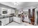 Open concept kitchen with granite countertops, stainless steel appliances, and open view to dining and living areas at 3619 Chilham Pl, Charlotte, NC 28226
