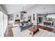 Well-lit living area with fireplace, hardwood floors, and views into kitchen and dining spaces at 3619 Chilham Pl, Charlotte, NC 28226