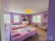 Charming bedroom with two twin beds and bright purple walls, creating a playful atmosphere at 438 Starcrest Cir # C, Rock Hill, SC 29730
